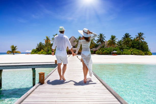 https://media.istockphoto.com/id/1196528669/photo/couple-walks-down-a-wooden-pier-in-the-maldives-indian-ocean.jpg?s=612x612&w=0&k=20&c=gIJMG4VRW4d55go9NBU-WYZkEZ8apLo_R1BMwbHHaFM=